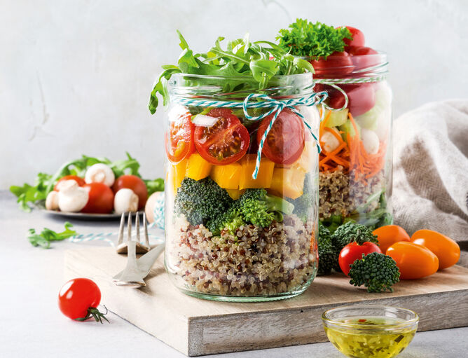 Merenda in barattolo su tavola di legno con verdure, mozzarella di pomodoro sullo sfondo con Bambini Mozzarella Mini di GOLDSTEIG 
