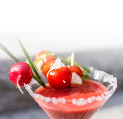 Ricetta cocktail alla mozzarella con Bambini Mozzarella Mini di GOLDSTEIG con bastoncini di pomodoro ciliegino e sugo di pomodoro in un bicchiere da cocktail con bordo di zucchero