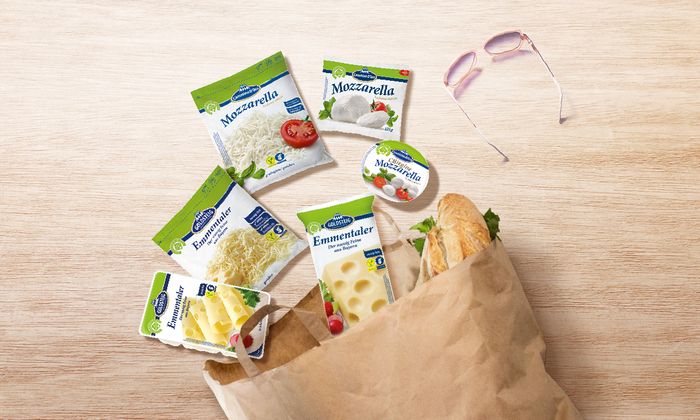 a range of products made by GOLDSTEIG with a baguette and sunglasses in a paper bag